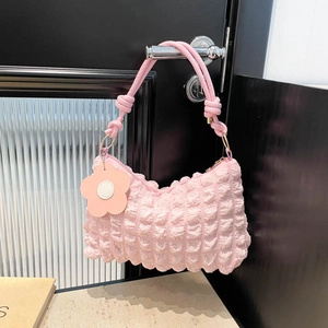 Pink bubble fabric cylinder handbag with floral charm and knotted shoulder strap detail