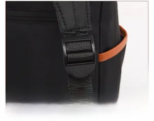 Détail de la boucle de sangle réglable et texture du tissu oxford sur le sac à dos noir