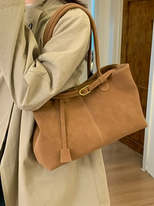 Minimalist caramel brown suede tote bag with shoulder strap and gold hardware