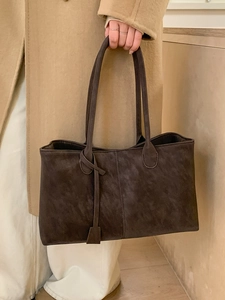Minimalist dark brown tote bag in distressed faux leather with knot shoulder strap