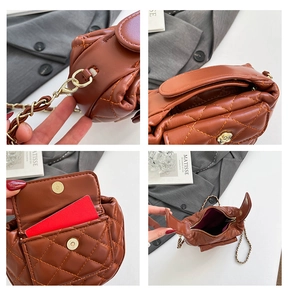Detail of brown quilted bag showing gold rose buckle, red card slots and chain strap