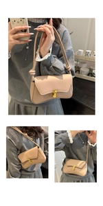 Detail of beige crossbody bag featuring wave curved bottom and golden oval twist lock