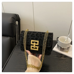 Detail of leopard print shoulder bag with gold chain strap and geometric metal buckle