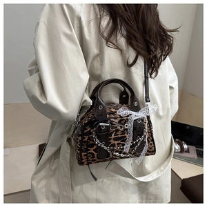 Detail of leopard print Boston bag with lace bow and silver chain strap for women