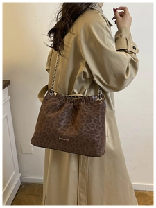 Detail view of brown leopard print tote bag with Creative Cat logo and chain strap