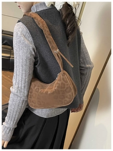 Brown leopard print suede shoulder bag shown from a side view on a model