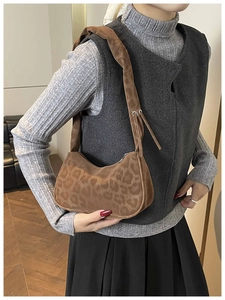 Close-up of leopard print shoulder bag in soft suede fabric on model's shoulder