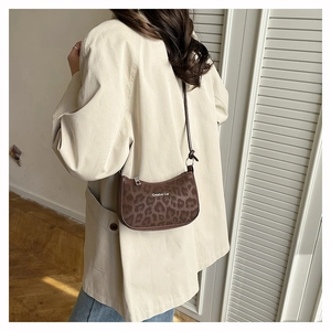 Leopard print underarm bag with Creative Cat text shown on a model for style