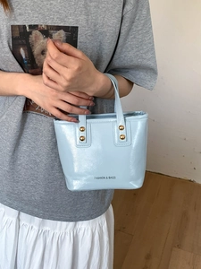 Light blue PU leather bucket bag with gold rivets and FASHION & BAGS lettering