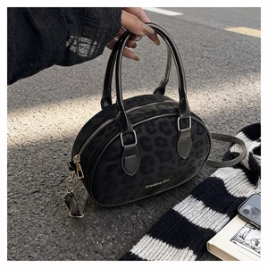 Detail of black leopard print Boston bag with metallic zipper and Creative Cat logo
