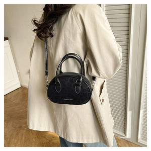 Detail of black faux leather Boston bag with subtle leopard print and creative text
