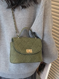 Green felt crossbody bag with diamond quilting and gold chain strap shown on model