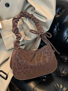 Brown leopard print suede underarm bag with pleated handle and ribbon bow detail