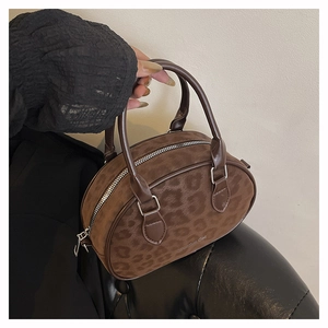 Detail shot of leopard print faux suede texture and zipper on the Boston bag