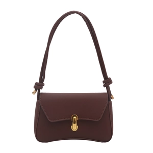 Minimalist deep brown leather crossbody bag with gold oval lock and knot strap detail