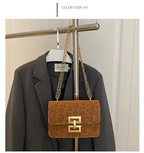 Brown leopard print crossbody bag with gold chain strap and square buckle detail