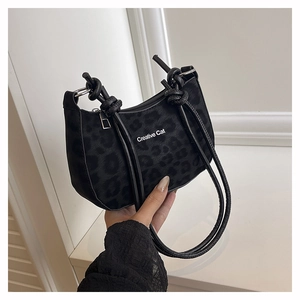 Detail of leopard print shoulder bag with Creative Cat logo and knotted straps