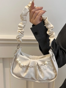 Chic beige pleated underarm bag with pearl chain and wavy strap for modern women