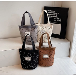 Corduroy lunch bags in black, grey, white, and brown with cute heart and bow patterns