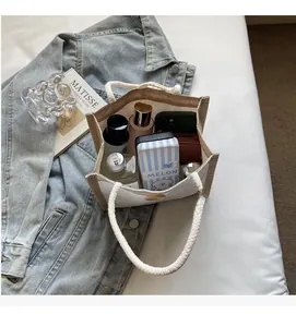 Spacious interior of linen tote showing storage for phone, wallet and cosmetics