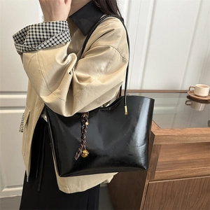 Glossy black oil wax leather tote bag for women with gold charm and shoulder straps