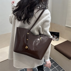 Deep brown oil-wax leather tote bag for women with golden ball charm and large capacity