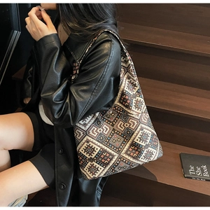 Grand sac cabas bohème aux motifs géométriques porté avec une veste en cuir