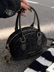 Matte black leopard print Boston bag with round handles and adjustable shoulder strap