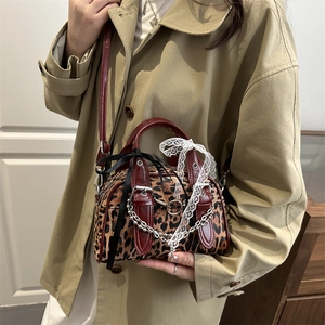 Retro leopard print mini crossbody bag with red patent leather trim and bow detail