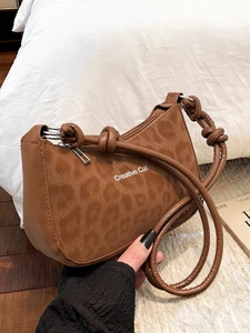 Brown leopard print crossbody bag with Creative Cat text and knotted shoulder strap