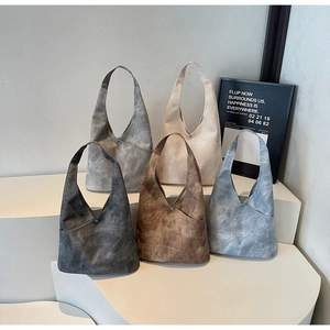 Detail view of large capacity bucket bags in five colors with vintage textured finish