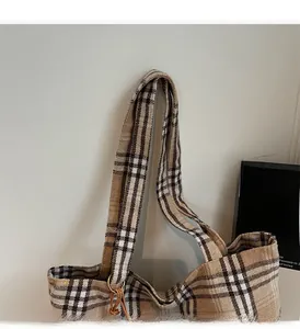 Detail of the durable check pattern canvas handle and side strap on the large tote bag