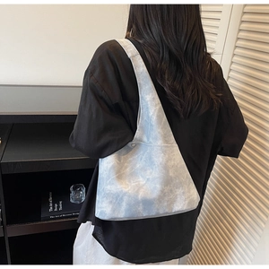 Detail of light blue cloud-textured hobo bag showing its spacious capacity and slouchy fit