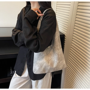 Detail view of large grey tote bag with marble texture shown in a minimalist setting