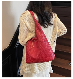 Close-up of red large hobo tote bag featuring a dense woven texture and soft structure