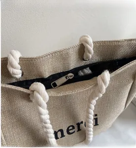Detailed view of large linen tote bag with smooth zipper closure and cotton rope handle