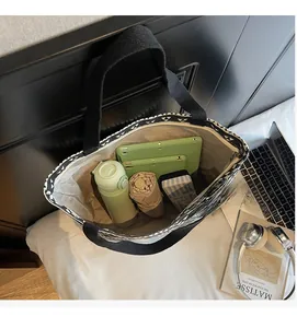 Top view of large canvas tote bag showing spacious interior with tablet and umbrella