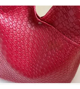 Close-up of vibrant red woven texture and square pattern on large capacity tote bag