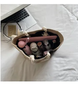 Spacious interior of beige straw tote bag showing storage for umbrella and cosmetics