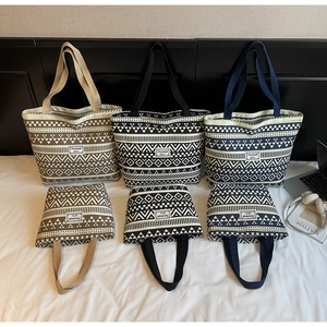 Detail of geometric canvas tote bags in various sizes and ethnic pattern colors
