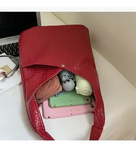 Spacious interior of red woven tote bag showing storage for tablet and daily items