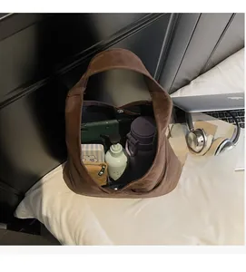 Interior view showing the large capacity and magnetic closure of the brown hobo tote bag