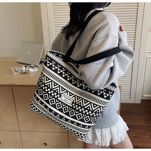 Detailed close-up of large canvas tote bag with black and white geometric ethnic patterns
