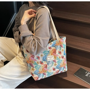 Close-up of ethnic jacquard tote bag with vintage floral patterns and woven straps