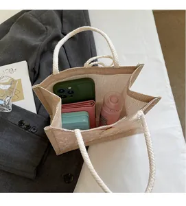 Top-down macro view showing spacious interior of beige woven tote bag with accessories