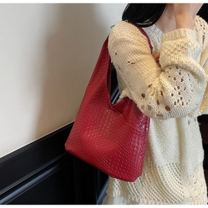 Close-up of red hobo bag featuring premium woven texture and large capacity structure