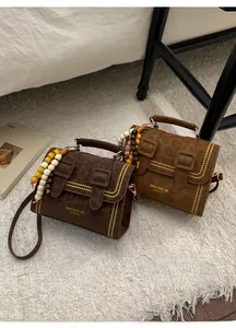 Detail of vintage leopard print crossbody bag with wooden beads and decorative stitching