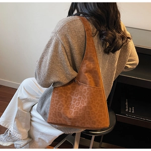Detailed view of a large leopard print tote bag with a vintage matte finish for commuting