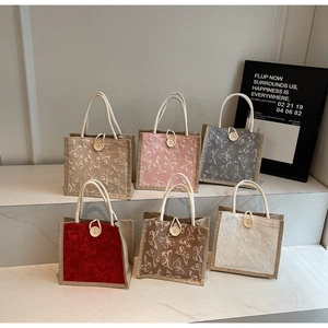 Detail of six colorful mini gift bags with butterfly embroidery and cotton rope handles