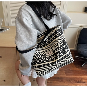 Detailed view of the large canvas tote bag featuring ethnic geometric patterns and logo tag
